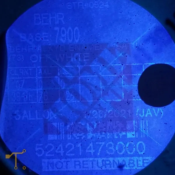 Closeup picture of a faded thermal label under a 365nm blacklight.