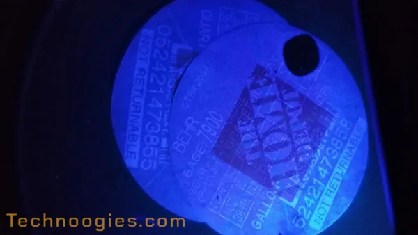 Image of a faded thermal printed label under 365nm blacklight.